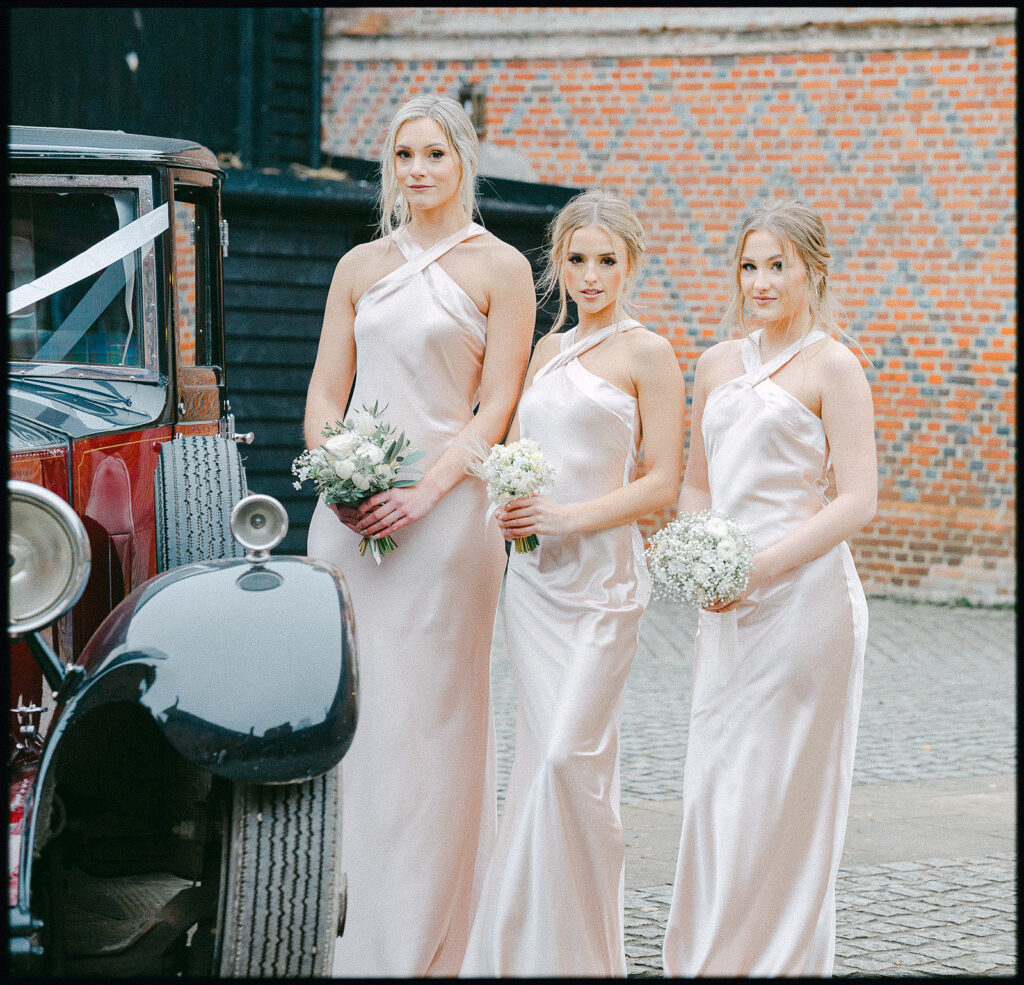 Bridesmaids and wedding car at layer marney tower essex. Tracey Davies Photography. Fine Art Wedding Photography Colchester. 
